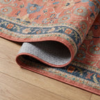 Calabria Coral Multicolor Rug corner folded back showing the bound edge and non slip backing