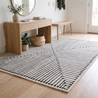 Inkdrop Black and Ivory Striped Rug in an entryway
