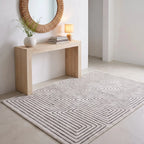 Labyrinth Black and Ivory Maze Rug in an entryway