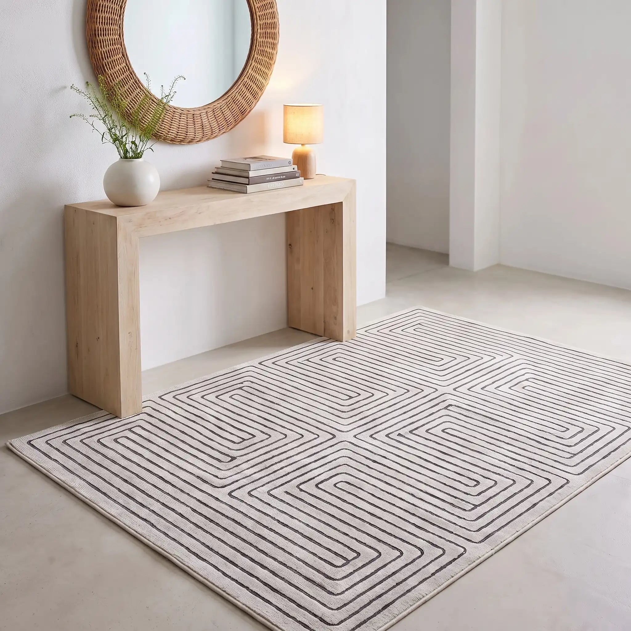 Labyrinth Black and Ivory Maze Rug in an entryway